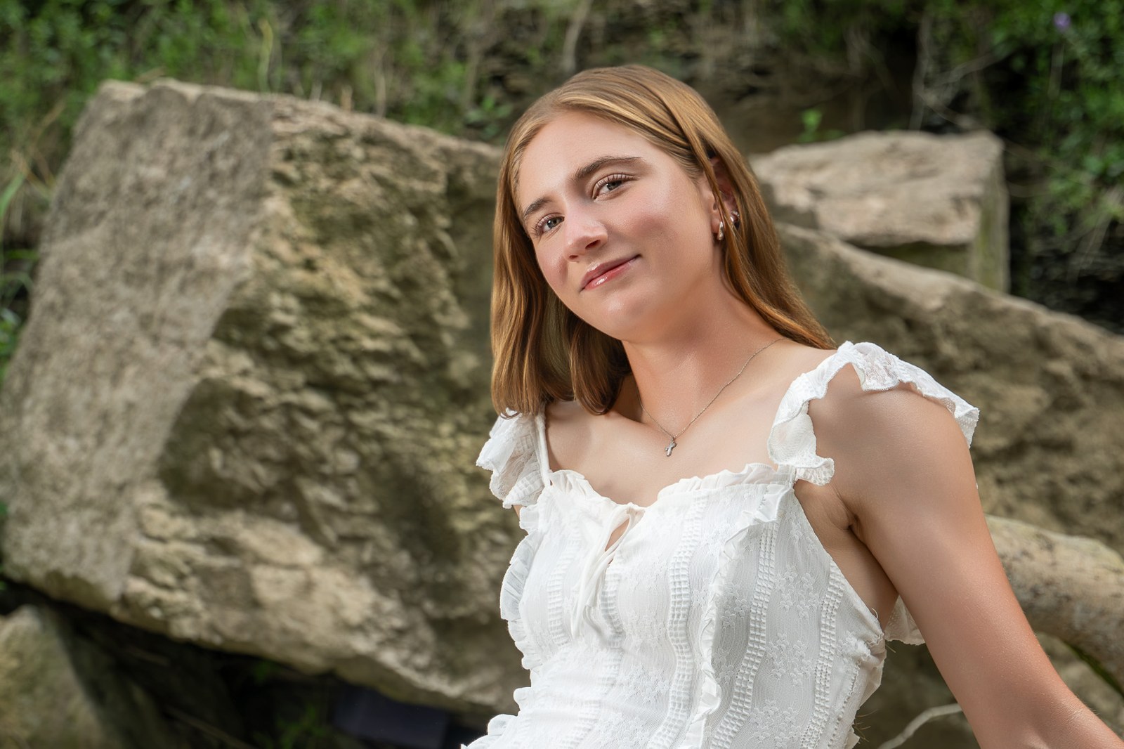 Senior portrait by a rock wall, Rochester NY