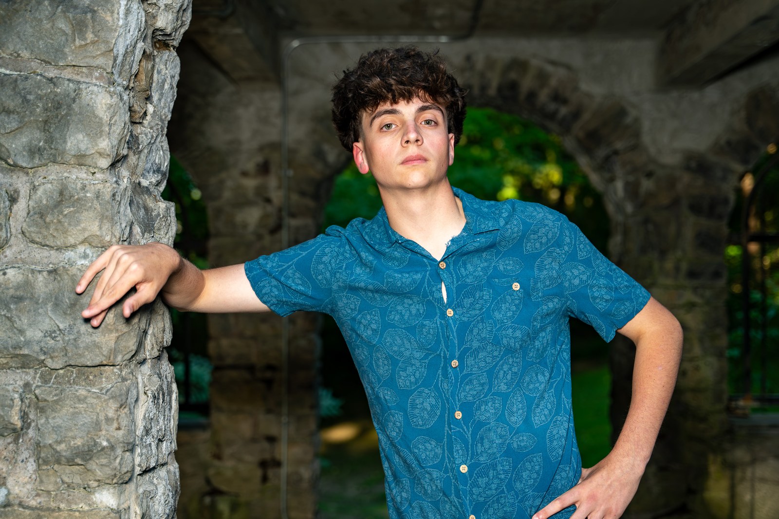 Senior portrait under a stone archway, Rochester NY